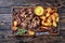 Overhead view of delicious slow roast tender leg of lamb pulled off the bones and served with crispy roast potatoes on a wooden