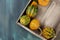 Overhead view of different kinds of Pumpkins or Squashes in a wooden tray