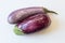 Overhead view of Dominican eggplants Solanum melongena food ingredients, isolated on white, horizontal aspect