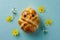 Overhead view of an easter chick made from hot cross buns