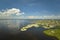 Overhead view of Everglades swamp with green vegetation between water inlets and rural private houses. Natural habitat