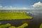 Overhead view of Everglades swamp with green vegetation between water inlets and rural private houses. Natural habitat