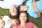 Overhead View Of Family Resting On Grass