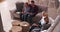 Overhead View Of Family Sitting On Sofa Watching Television