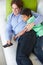 Overhead View Of Father And Son Relaxing On Sofa Watching TV