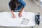 overhead view of female fashion designer measuring space for print on empty white t-shirt