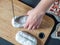 Overhead View Female Hands Cut German Marzipan Stollen With Knife On Wooden Board