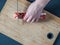 Overhead View Female Hands Cut Strawberry Nougat With Knife On Wooden Board