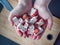 Overhead View Female Hands Hold Strawberry Nougat Over Knife On Wooden Board