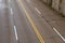 Overhead view of a four lane road and sheer wall wet from recent rain