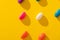 Overhead view of fresh multi colored candies arranged in a row on yellow background