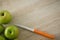 Overhead view of granny smith apple by kitchen knife