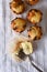 Overhead view of a group of mini chocolate chip muffins on a kitchen towel.