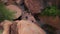 Overhead view of hikers hopping from boulder to boulder on hike