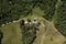 Overhead view of a house with a tin roof in the middle of nature