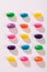 Overhead view of multi colored candies in a row over white background