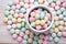 overhead view of pastel macarons on a wooden table