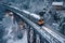 overhead view of polar express train crossing a snowy bridge