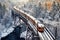 overhead view of polar express train crossing a snowy bridge