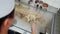 Overhead view of professional cook cooking vegetable noodle dish on a hot plate. Top down view of chef mixing vegetables