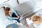 overhead view of psychotherapist writing on clipboard while young patient sitting