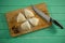 Overhead view of raw cookies by knife on cutting board