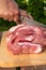 Overhead view of raw piece of pork on wooden background. Piece of fresh boneless pork, neck part or collar. Big piece of red raw m