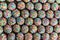 Overhead view of rows of small round cookies covered with colorful sprinkles