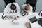 overhead view of scientific researchers in white coats working together at workplace