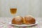 Overhead view of Shabbat eve table with uncovered challah bread and Kiddush wine cup. copy space. Challah and wine on the Sabbath