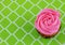 Overhead view of a single cupcake with rose shaped pink frosting