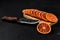 Overhead view of slices of blood orange on black background