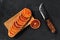 Overhead view of slices of blood orange on black background