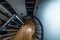 Overhead view spiral wooden steps going down indoor