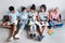 Overhead view of students of different nationalities sitting on the floor with laptops and notebook. Portrait of friends