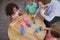 Overhead View Of Teacher And Pupils At Desk In Montessori School