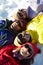 Overhead View Of Teenage Family Lying In Snow