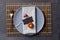 Overhead view of thanksgiving place setting with tag and autumn decoration on slate