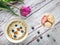 Overhead view to violet tulip and oatmeals in bowl with macaroons and berries