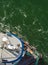 Overhead view of tugboat, ropes and workers assisting ship to dock, Alaska, USA.