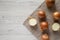 Overhead view, unpeeled raw yellow onions over white wooden surface, top view. Flat lay, flat lay, from above