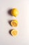 Overhead View Of Whole And Halved Fresh Lemons On White Background