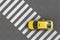 Overhead view of a yellow taxi over a pedestrian crossing