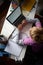 Overhead View Of Young Boy Studying In Bedroom Using Laptop