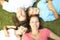 Overhead View Of Young Family Lying On Grass In Park