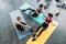 overhead view of young multicultural sportswomen resting on mats after training