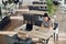 Overhead view of young woman checking time on her smartwatch while working on her laptop at a cafe. Top view shot of