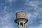 An overhead water tank with blue sky background