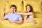 Overhead of young couple in bed. Pretty redhead woman angry with sleeping husband