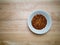 Overheard shot of porcelain bowl filled with red pepper flakes